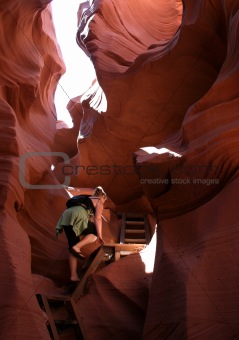 young woman hiking in slot canyon