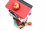 Large piles of books with apples on white