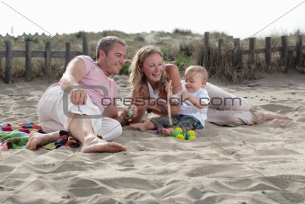playful family on the beach