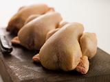 Three Whole Poussins on a Chopping Board