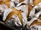 Tray of Jacket Potatoes Wrapped in Foil