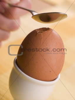 Boiled Egg being cracked open with a spoon