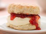 Scone Filled with Strawberry Jam and Clotted Cream on a plate