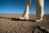 Man walking in desert, low section, , 