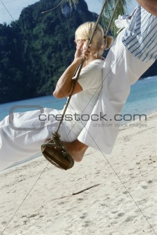 Couple on swing at beach
