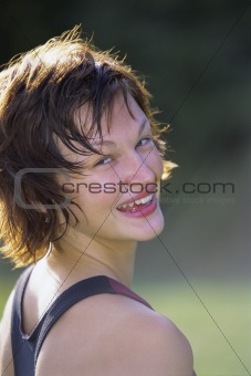 Sportswoman looking over shoulder and smiling at camera