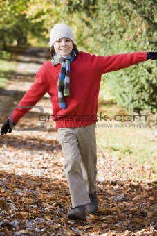 Young boy playing in woods
