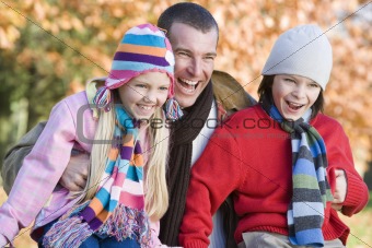 Father and children on autumn walk