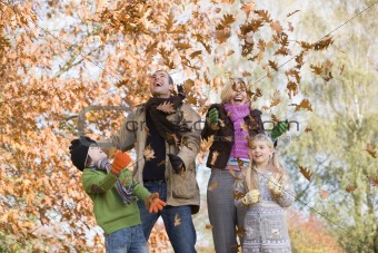 Family throwing leaves in the air
