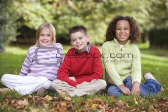 Group of children sitting in garden