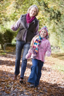 Grandmother and granddaughter playing in woods