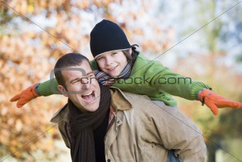Father giving son piggyback
