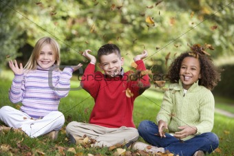 Group of children playing in leaves