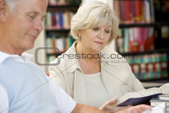 Adult students reading in a library