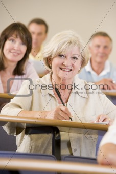 Senior woman listening to a university lecture