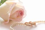 Wedding rings, pearl beads and rose, isolated