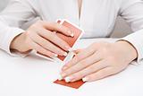 Woman peeping in under playing card