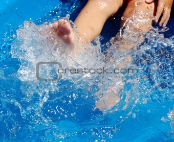 Boy kicking in pool