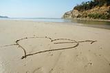 Heart with arrow on a beach