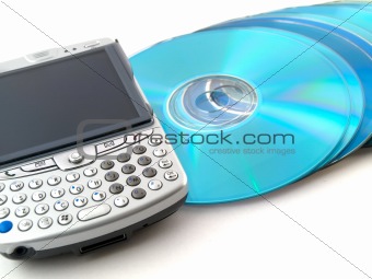 CDs DVDs and Mobile Phone PDA on White Background