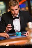 Man gambling at roulette table in casino