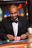 Man gambling in casino at roulette table