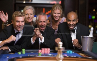 Group of friends celebrating win at roulette table