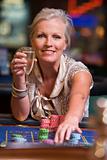 Woman gambling at roulette table