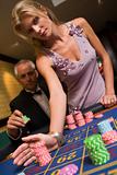 Couple placing bet at roulette table