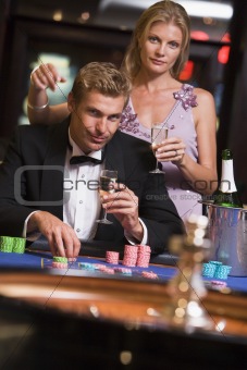 Couple gambling at roulettte table