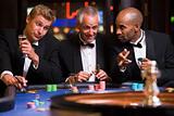 Three men gambling at roulette table