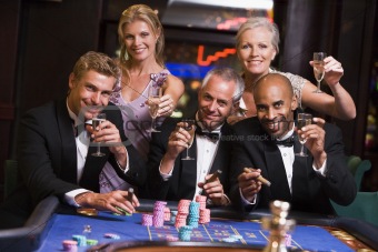 Group of friends gambling at roulette table