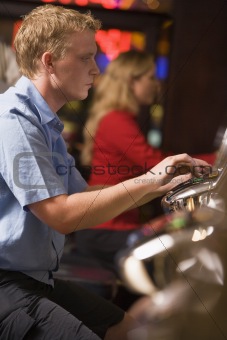 Man playing slot machines