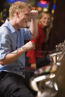 Man celebrating win at slot machine 