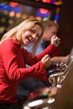 Woman celebrating win at slot machine