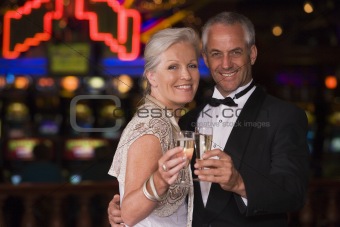Mature couple celebrating in casino