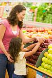Mother and daughter in produce section