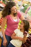 Mother and daughter shopping in produce section