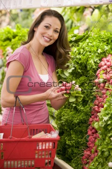 Woman shoppping in produce section 