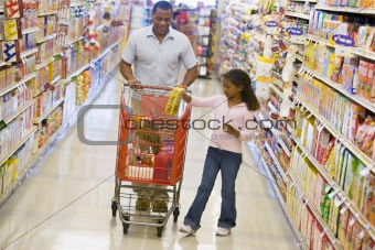 Father and daughter shopping in supermarket