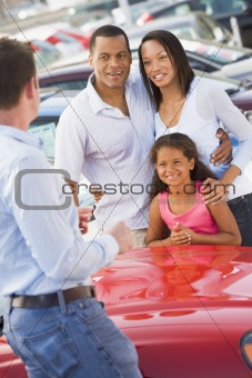 Young family collecting new car