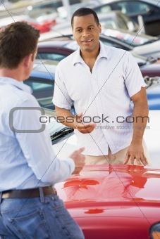 Man talking to car salesman