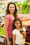 Mother and daughter buying fresh fruit