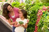 Mother and daughter choosing fresh produce