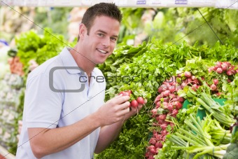 Young man shopping for fresh produce