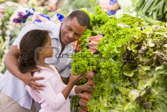 Father and daughter buying fresh produce