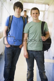 Male college students standing in university corridor