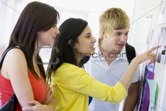 College students looking at a bulletin board