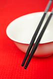 Pair of chopsticks and white bowl