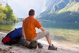 Hiker relaxing at a mountain lake
